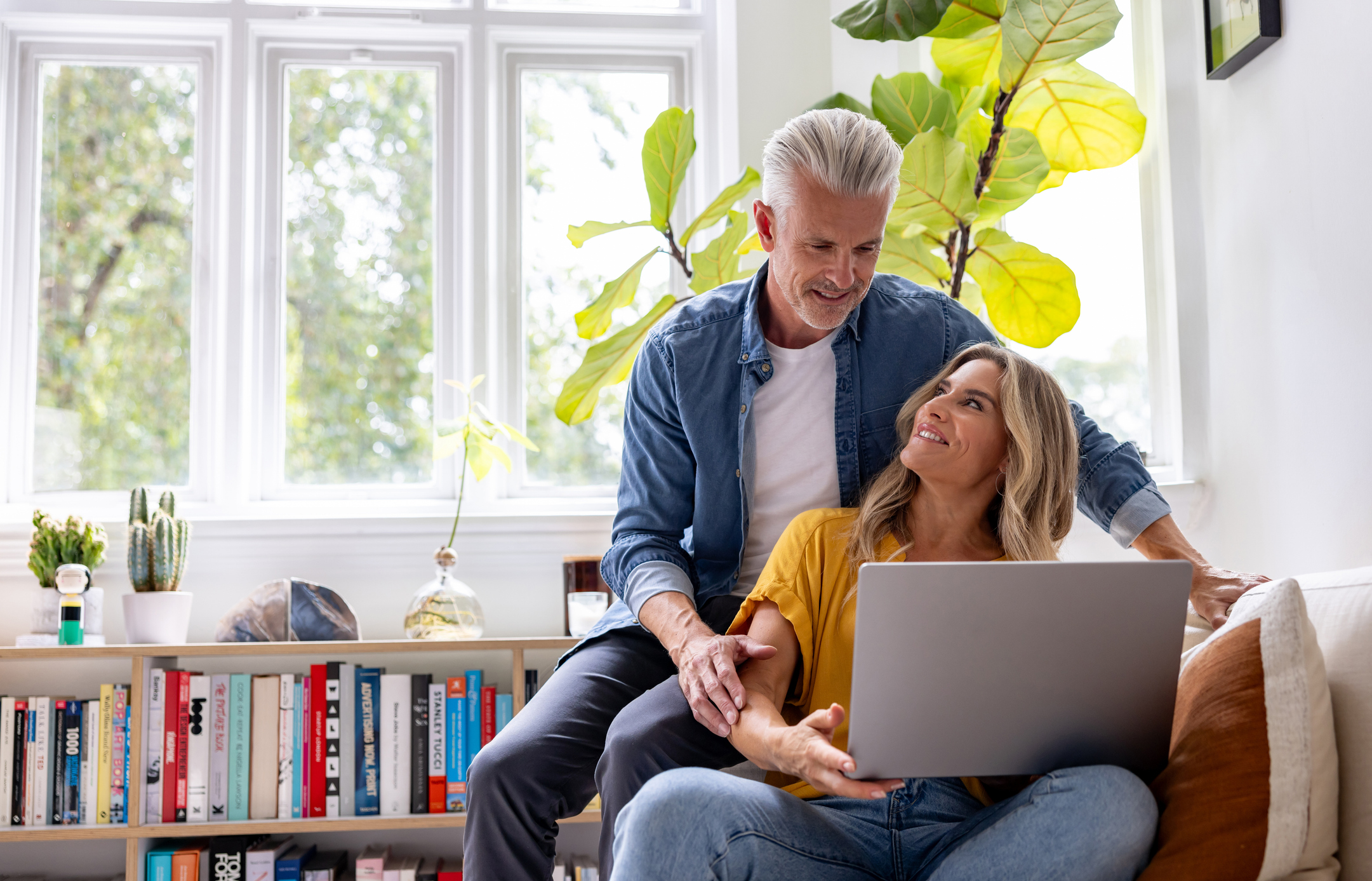 Happy couple with laptop at home